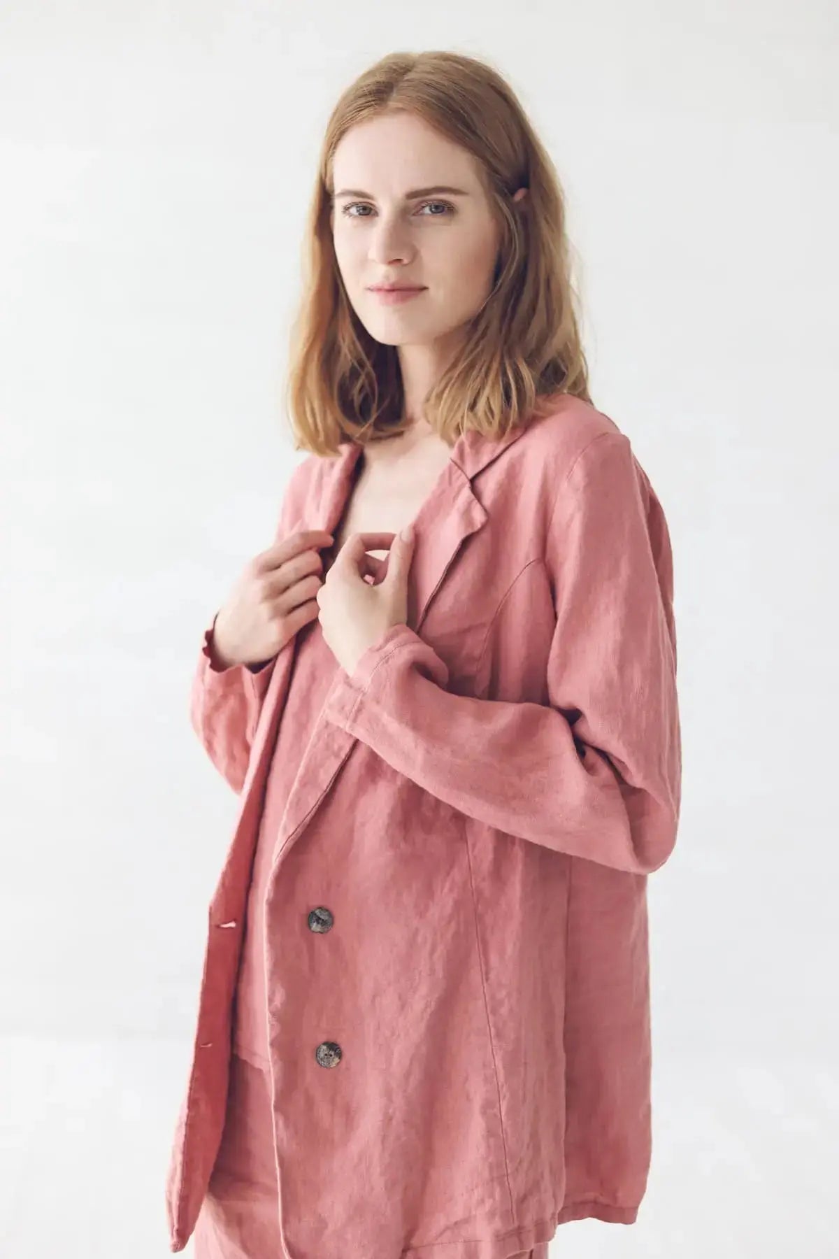 Model wearing classic linen jacket adjusting the collar