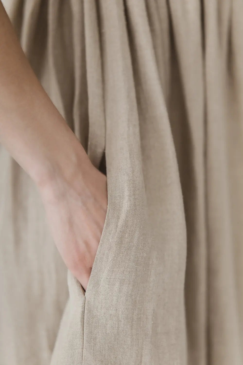 Close-up of side pocket on natural linen gathered maxi dress
