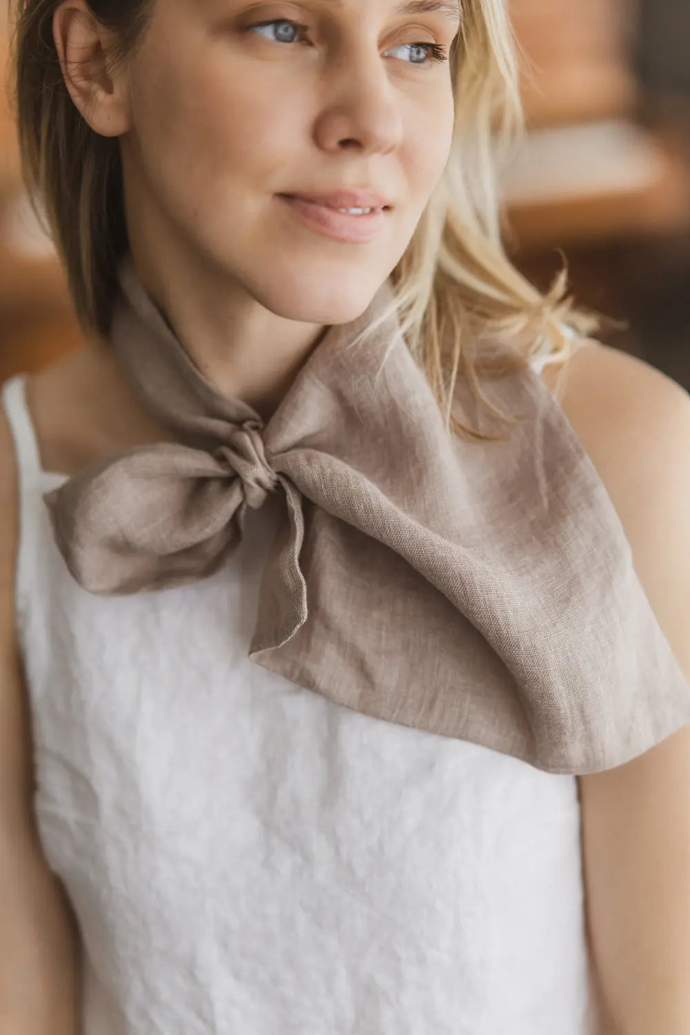Close-up of a light brown gauze linen scarf with a built-in loop