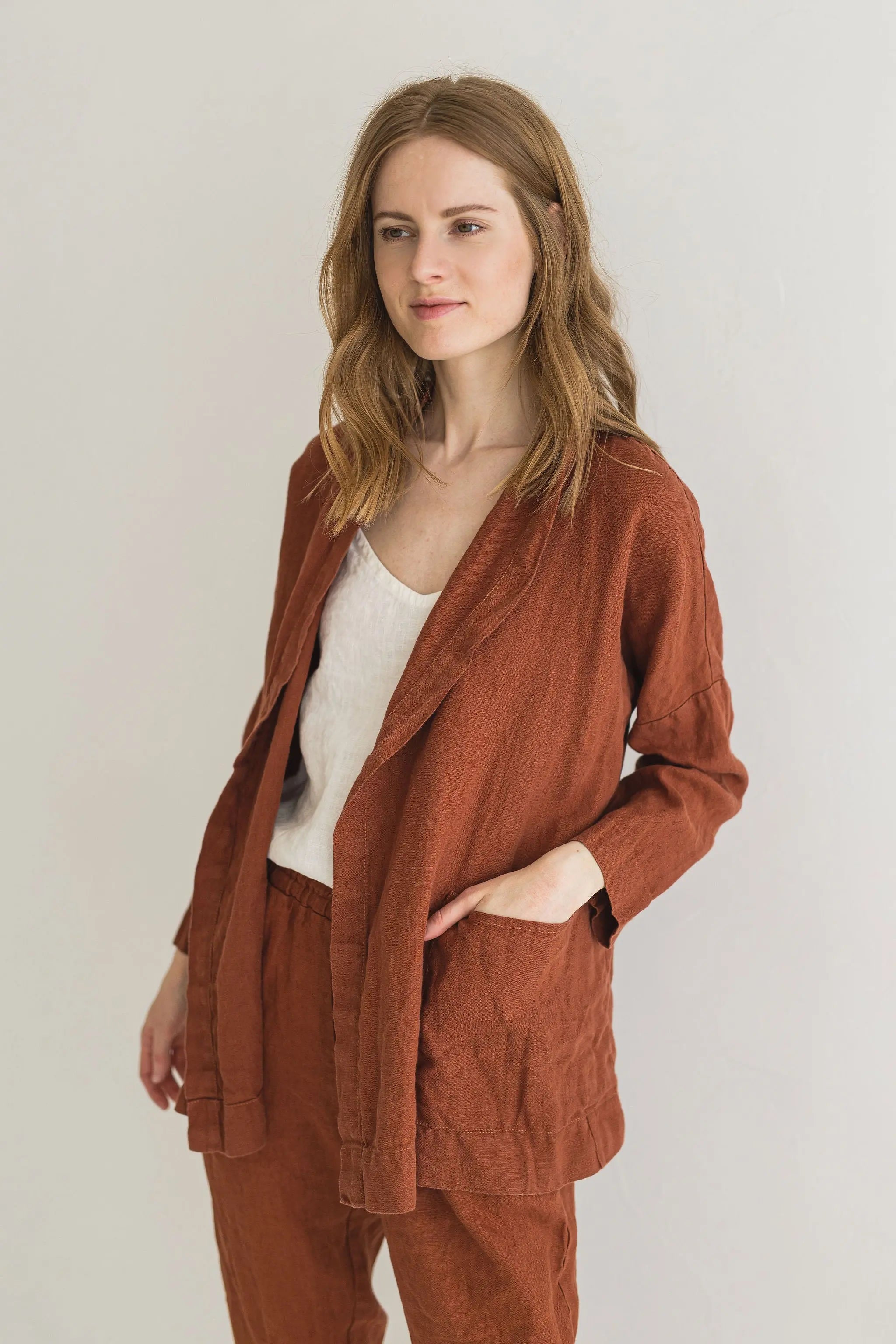 Woman wearing a brown outfit against a plain background