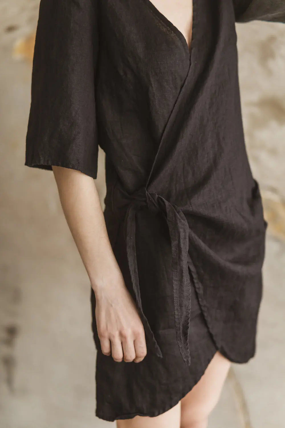 Close-up of the V-neckline and shoulder detail of the premium linen wrap dress