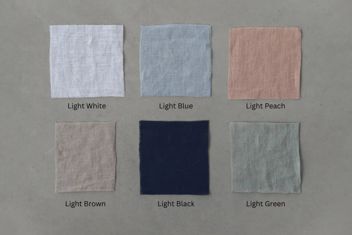 Six square fabric samples in light colors on a gray background