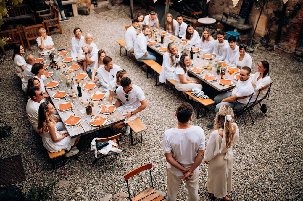 Group of people at an outdoor event, couples speaking. Explore our premium outdoor event table linen from a top linen wholesale website, featuring durable tablecloths, weather-resistant linen napkins, stylish linen table runners, and high-quality linen placemats. Ideal for weddings, parties, and corporate events, our outdoor table linens offer elegance and functionality, making them perfect for any occasion.