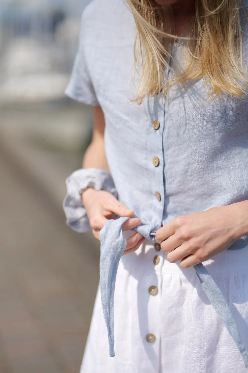 Close up of bow top from light blue 100
% natural linen