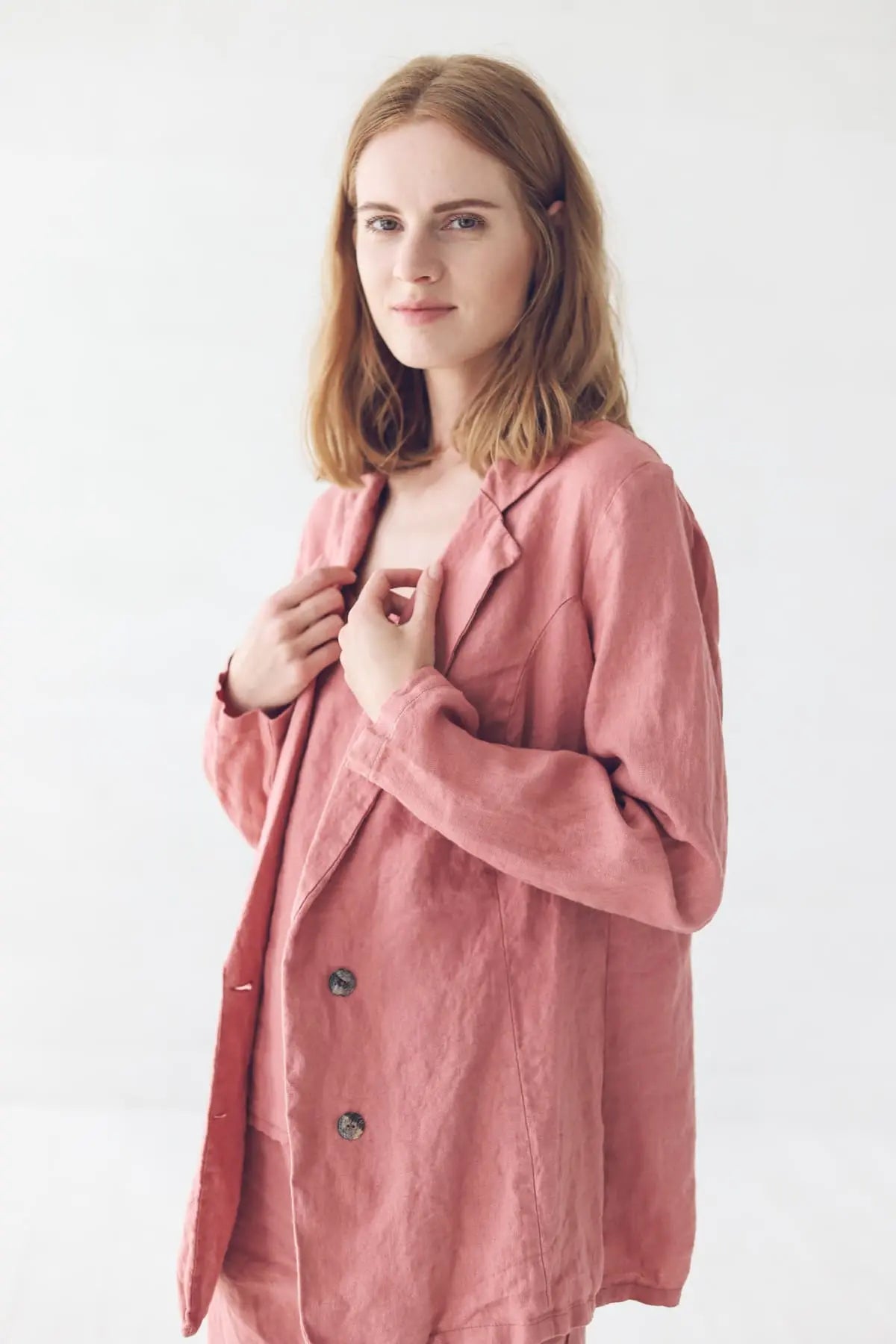 Model wearing classic linen jacket adjusting the collar