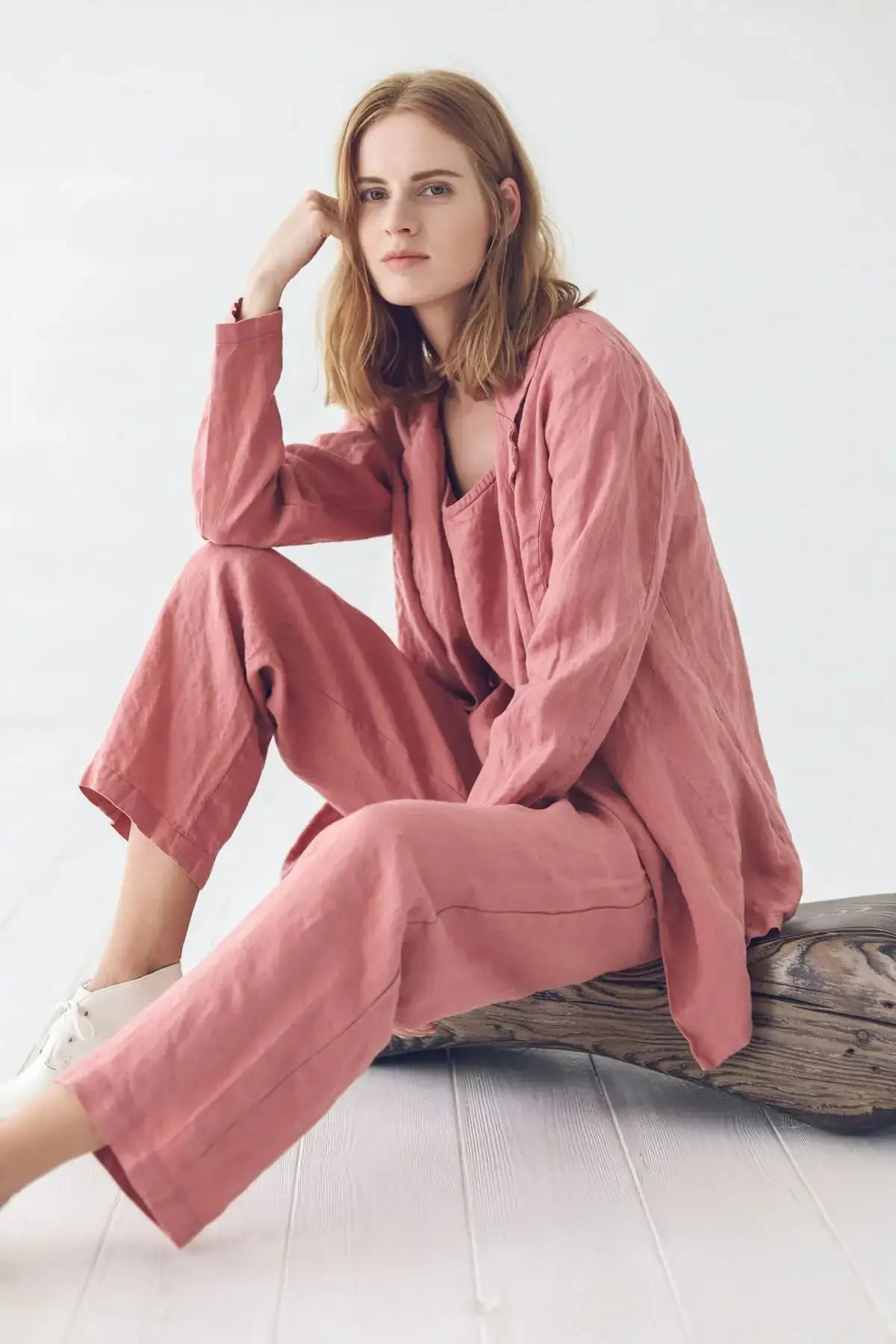 Close up detail of a linen jacket while model is sitting comfortably