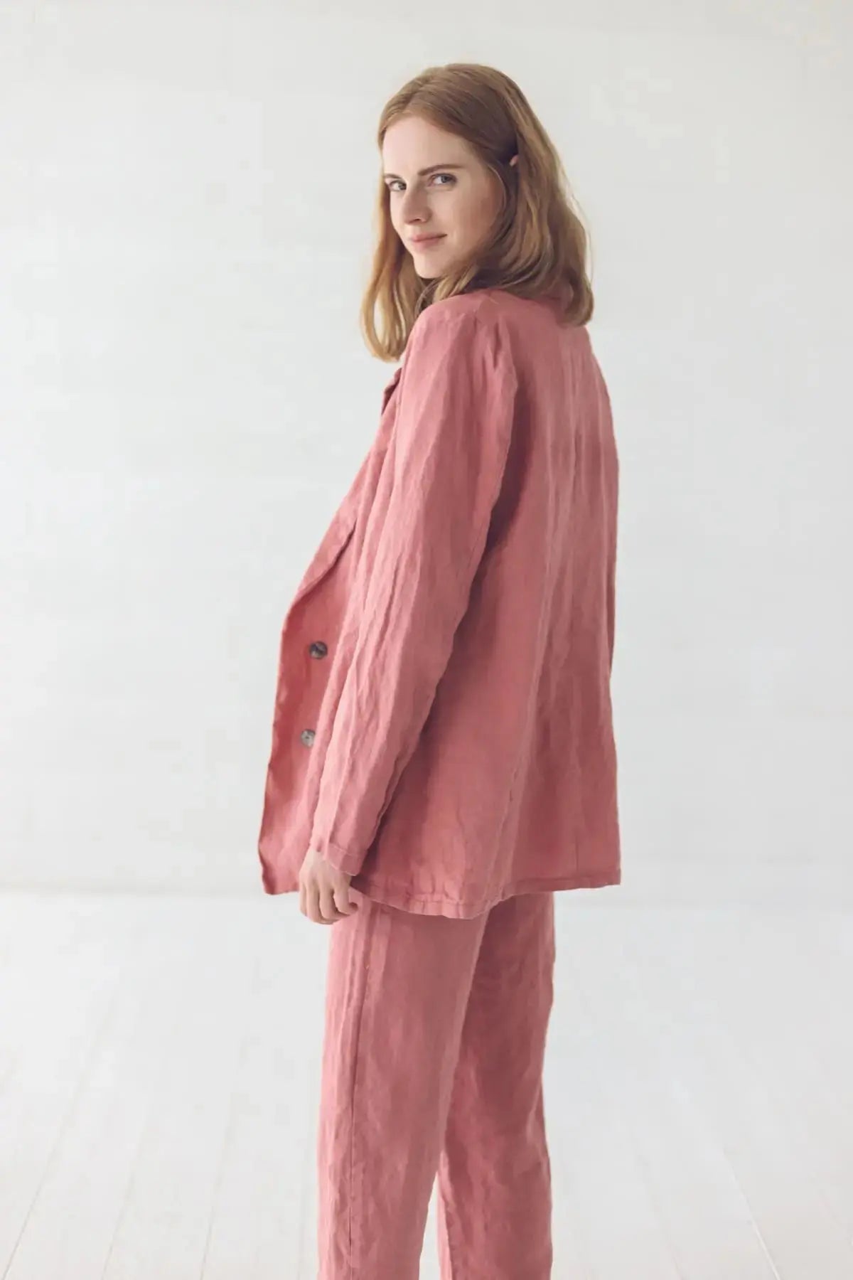 Side view showing the silhouette and sleeve fit of the linen jacket