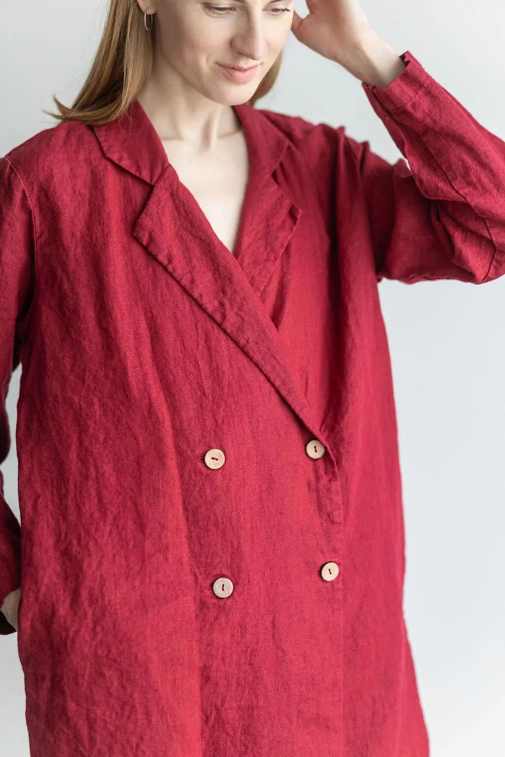 Close-up of a red double-breasted linen jacket with wooden buttons