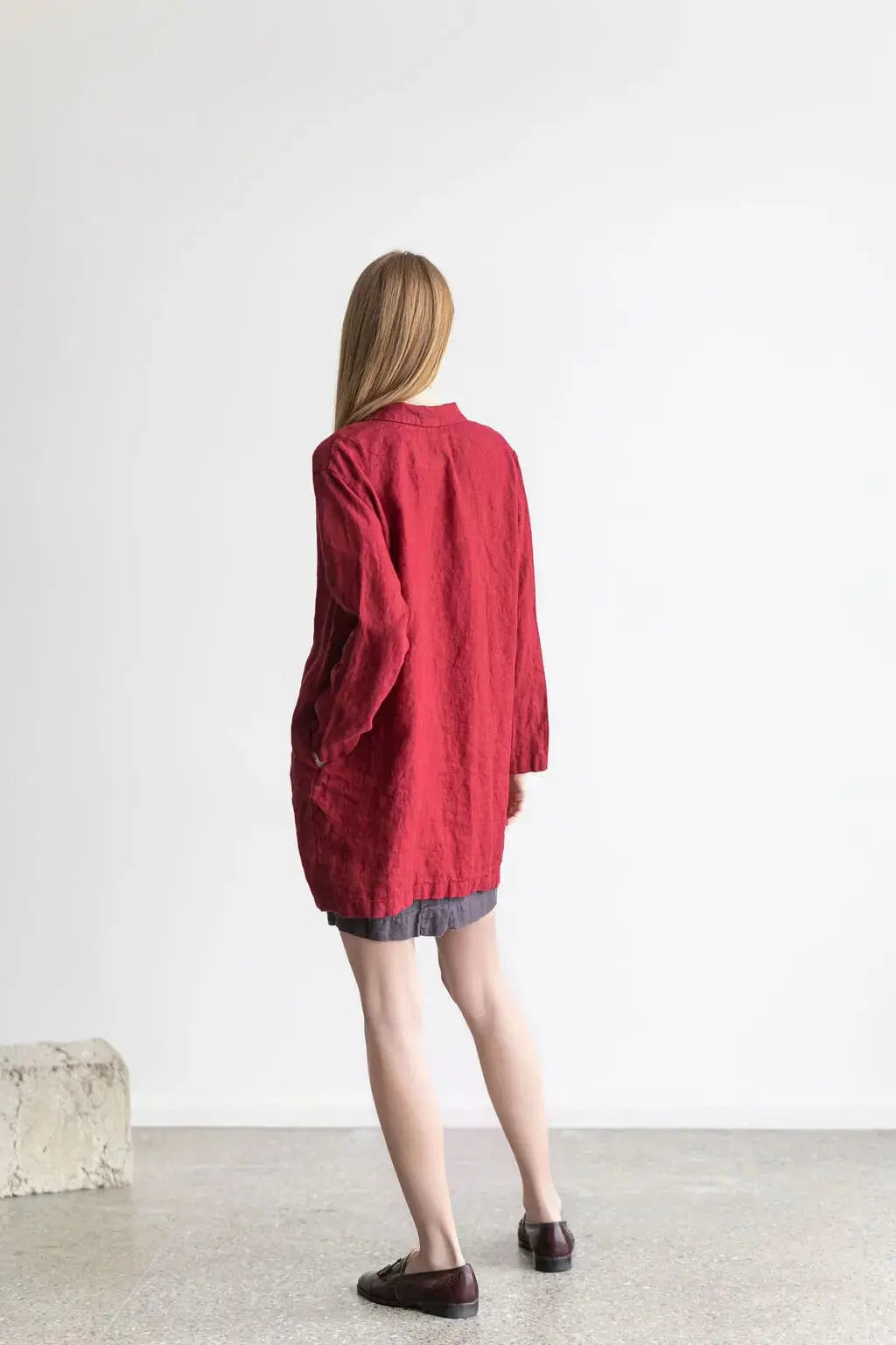 Back view showing the tailored fit and silhouette of a red linen jacket